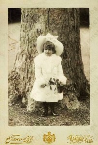 Marie as a child by a tree